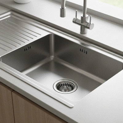 Close up of a kitchen sink drain with water residue